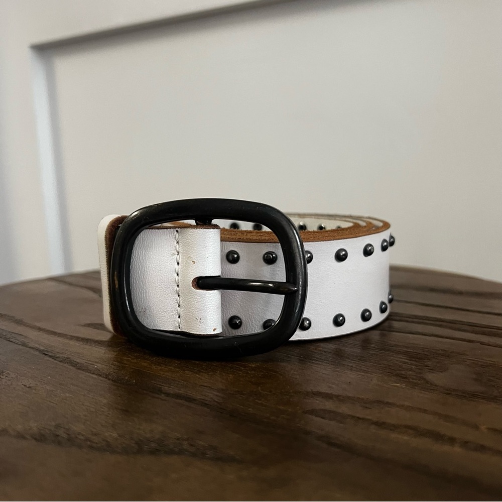 White leather belt with dark silver studs and hardware